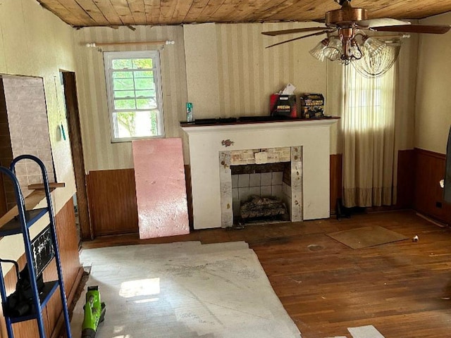 122 W Lake St, Camden, TN 38320 - living room featuring wood ceiling, hardwood / wood-style flooring, a fireplace, a ceiling fan, and wood walls