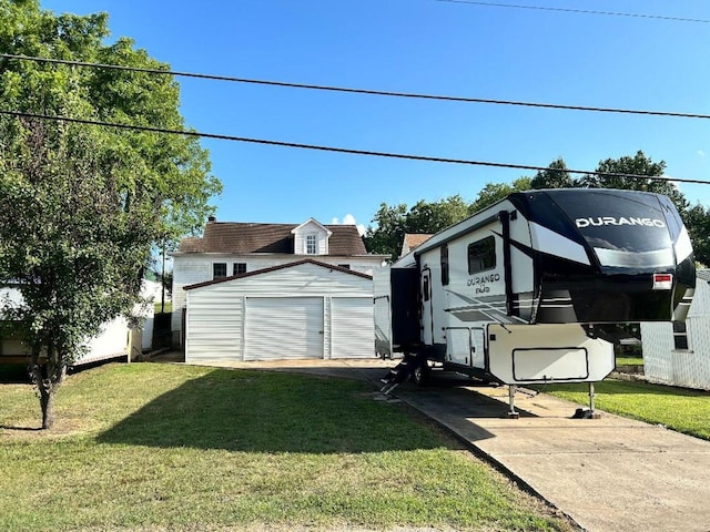 122 W Lake St, Camden, TN 38320 - view of grassy yard featuring an outbuilding and a detached garage