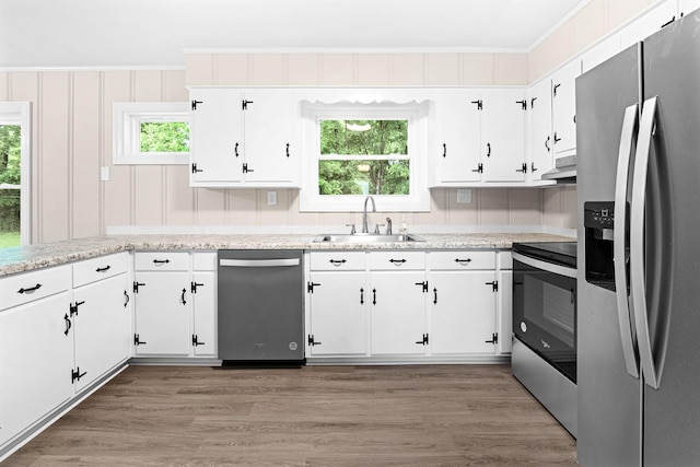 101 Arnold Ln, Murfreesboro, TN 37127 - kitchen with stainless steel appliances, healthy amount of natural light, extractor fan, white cabinets, and crown molding