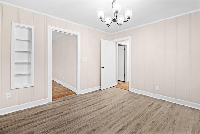 101 Arnold Ln, Murfreesboro, TN 37127 - unfurnished dining area with a chandelier, ornamental molding, wood finished floors, and a decorative wall