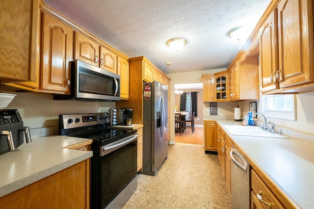 841 Marble Top Rd, Chickamauga, GA 30707 - kitchen featuring appliances with stainless steel finishes, glass insert cabinets, light countertops, brown cabinets, and a textured ceiling