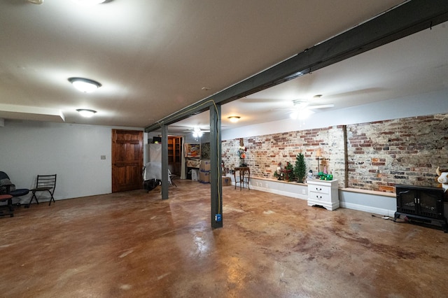 841 Marble Top Rd, Chickamauga, GA 30707 - basement featuring a wood stove, ceiling fan, and brick wall