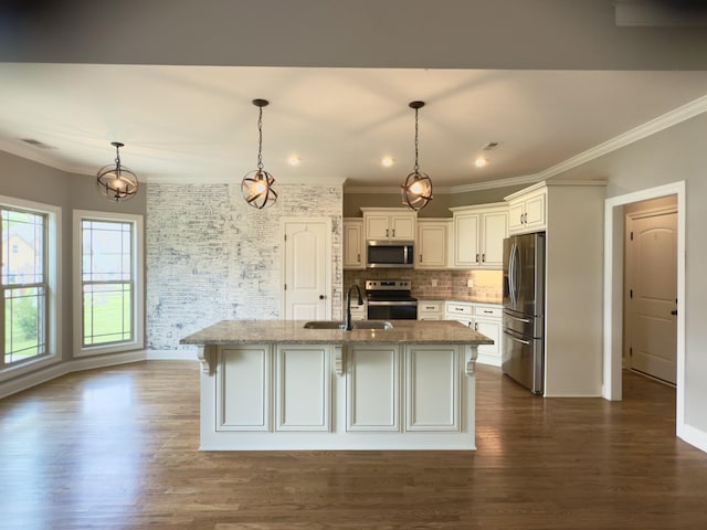 5120 Prickly Pine Pl, Murfreesboro, TN 37129 - kitchen featuring appliances with stainless steel finishes, ornamental molding, light stone counters, dark wood-style flooring, and a center island with sink