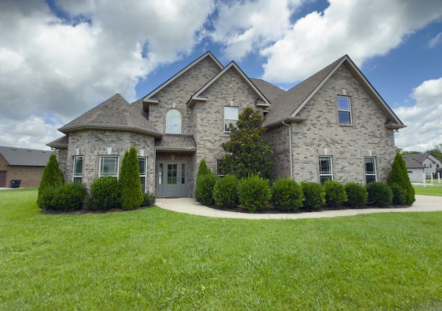 5120 Prickly Pine Pl, Murfreesboro, TN 37129 - french country inspired facade featuring brick siding, a front lawn, and roof with shingles