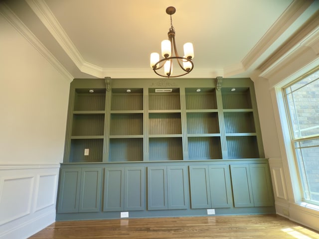 5120 Prickly Pine Pl, Murfreesboro, TN 37129 - unfurnished dining area with a chandelier, crown molding, a decorative wall, light wood-style floors, and a wainscoted wall