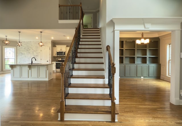 5120 Prickly Pine Pl, Murfreesboro, TN 37129 - stairs featuring crown molding, a chandelier, and wood finished floors