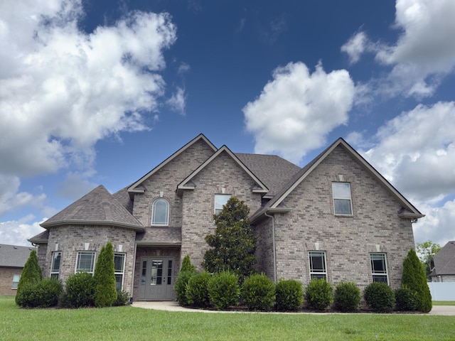 5120 Prickly Pine Pl, Murfreesboro, TN 37129 - view of front facade with brick siding, a front yard, and a shingled roof