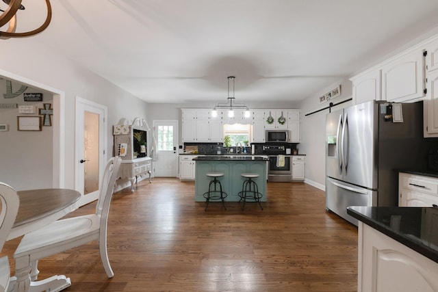 114 Deerview Dr, Columbia, TN 38401 - kitchen featuring a barn door, dark countertops, white cabinets, and stainless steel appliances