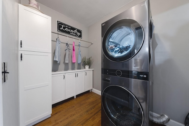114 Deerview Dr, Columbia, TN 38401 - laundry area featuring stacked washer / dryer, cabinet space, and dark wood-style floors