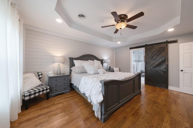 114 Deerview Dr, Columbia, TN 38401 - bedroom featuring a tray ceiling, a barn door, recessed lighting, wood finished floors, and ceiling fan