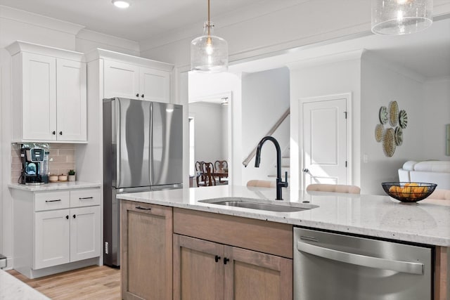 8665 Woodbury Acre Ct, Harrison, TN 37341 - kitchen with appliances with stainless steel finishes, white cabinets, light stone counters, decorative backsplash, and light wood finished floors