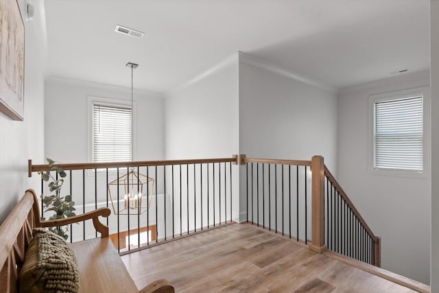 8665 Woodbury Acre Ct, Harrison, TN 37341 - hallway featuring wood finished floors, crown molding, and an upstairs landing