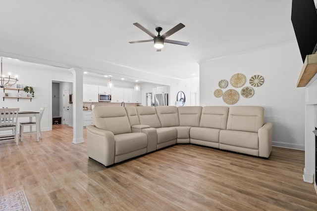 8665 Woodbury Acre Ct, Harrison, TN 37341 - living area with a ceiling fan, light wood-type flooring, crown molding, and a chandelier