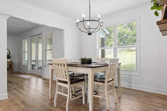 8665 Woodbury Acre Ct, Harrison, TN 37341 - dining space featuring ornamental molding, a chandelier, plenty of natural light, and light wood-type flooring