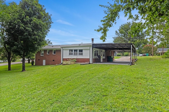 435 Forest St, Lewisburg, TN 37091 - back of house with a carport, brick siding, and a lawn