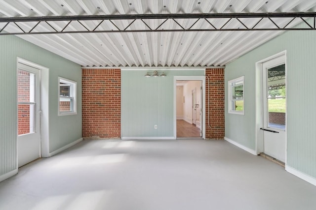 435 Forest St, Lewisburg, TN 37091 - empty room with finished concrete floors and brick wall