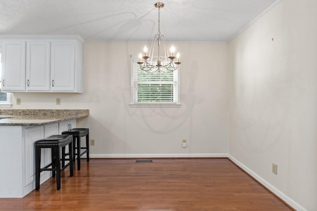 435 Forest St, Lewisburg, TN 37091 - unfurnished dining area featuring a chandelier, wood finished floors, crown molding, and a textured ceiling