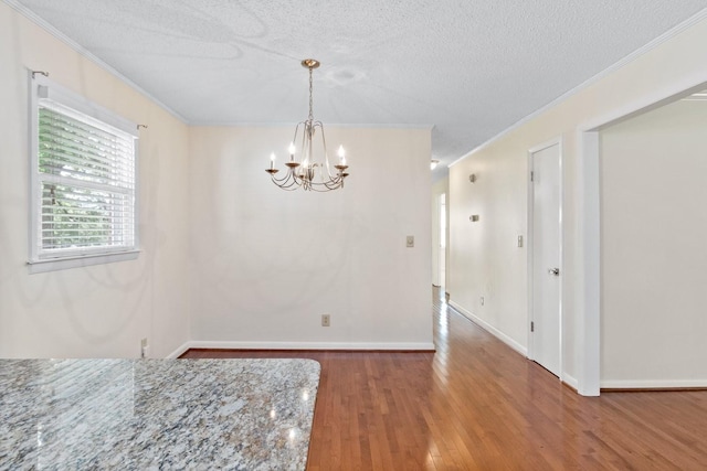 435 Forest St, Lewisburg, TN 37091 - unfurnished dining area featuring a chandelier, ornamental molding, wood finished floors, and a textured ceiling