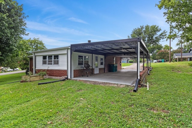 435 Forest St, Lewisburg, TN 37091 - back of house with an attached carport, a lawn, and brick siding