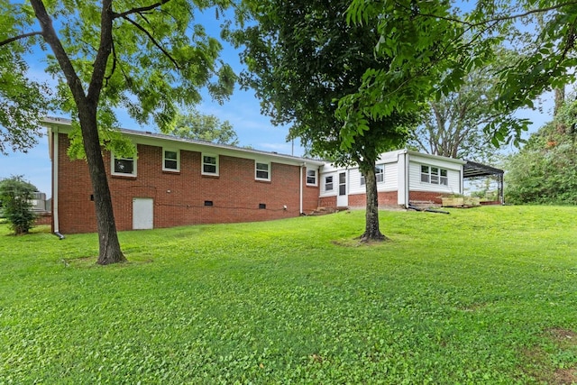 435 Forest St, Lewisburg, TN 37091 - back of house with crawl space, a yard, a carport, and brick siding