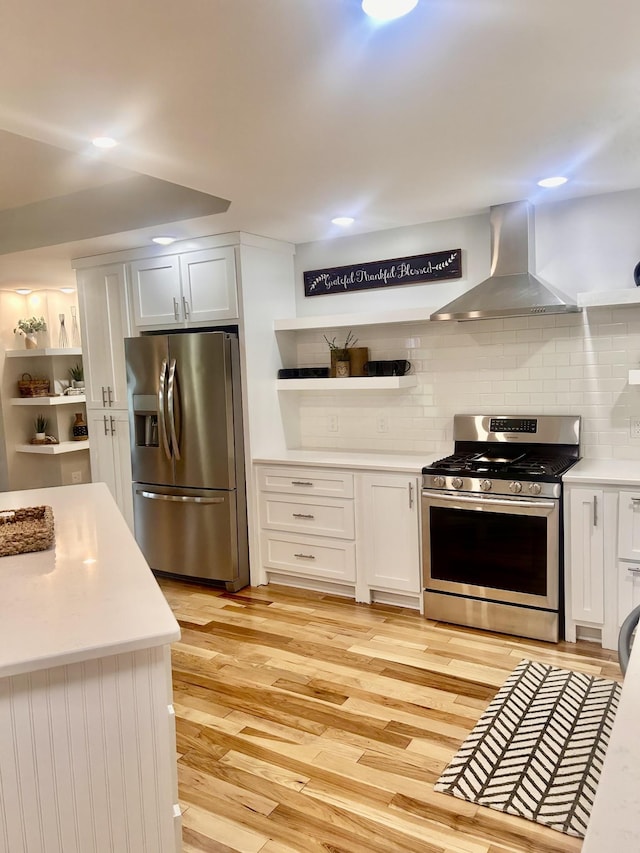 1059 S Cross Bridges Rd, Mount Pleasant, TN 38474 - kitchen with appliances with stainless steel finishes, wall chimney exhaust hood, light wood-style flooring, open shelves, and light countertops