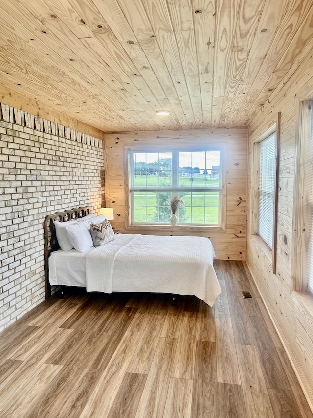 1059 S Cross Bridges Rd, Mount Pleasant, TN 38474 - bedroom with wood ceiling, wood finished floors, wood walls, and brick wall