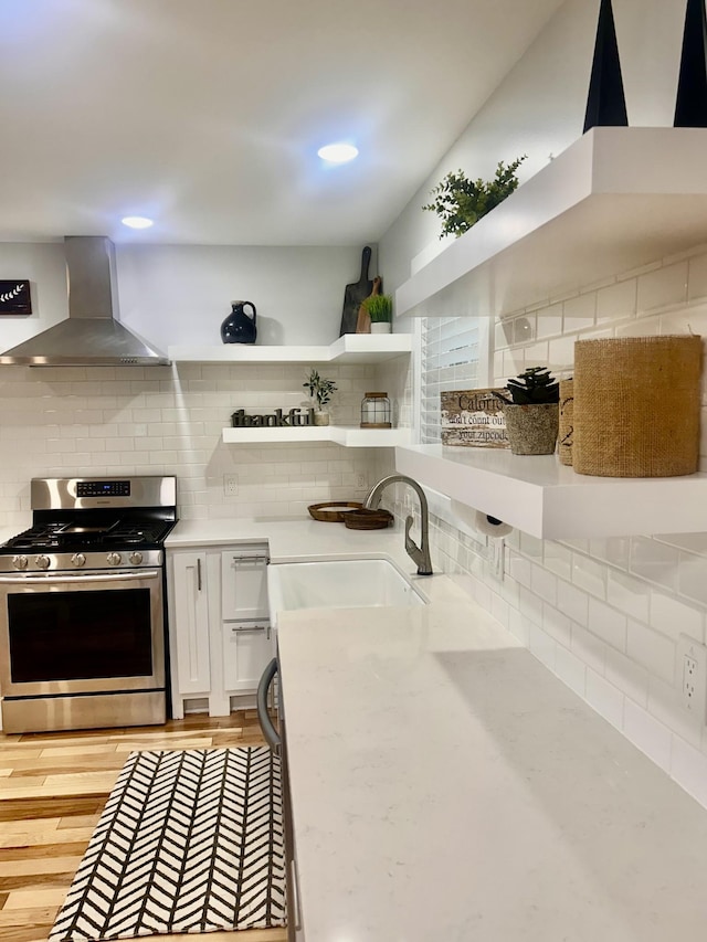 1059 S Cross Bridges Rd, Mount Pleasant, TN 38474 - kitchen with stainless steel gas stove, wall chimney range hood, decorative backsplash, open shelves, and light countertops