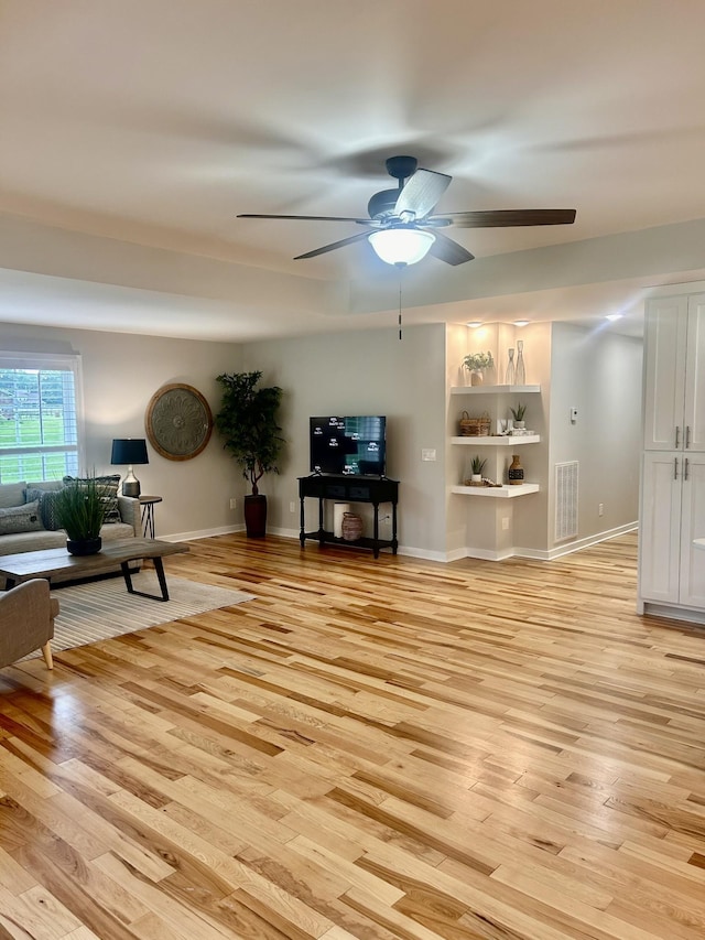 1059 S Cross Bridges Rd, Mount Pleasant, TN 38474 - living room with a ceiling fan, light wood-style floors, and built in shelves