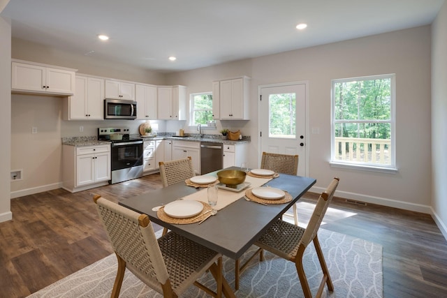 766 Billy Wynn Rd, Dickson, TN 37055 - kitchen featuring appliances with stainless steel finishes, dark wood-style flooring, white cabinetry, and recessed lighting