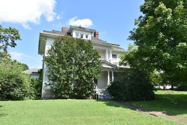 704 Main St N, Carthage, TN 37030 - view of front of home featuring covered porch, a front yard, and a chimney