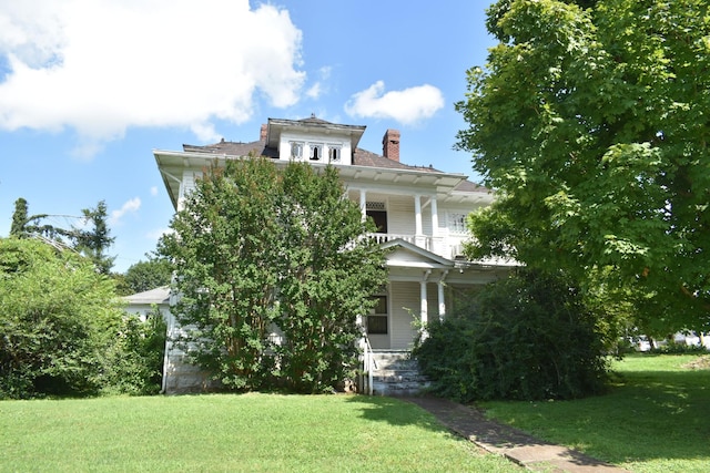 704 Main St N, Carthage, TN 37030 - view of front of home featuring a porch, a front yard, a chimney, and a balcony