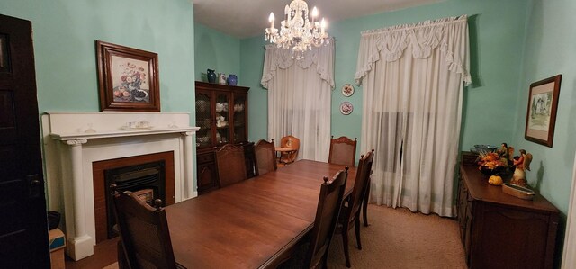704 Main St N, Carthage, TN 37030 - dining space with a chandelier, a fireplace, and light carpet