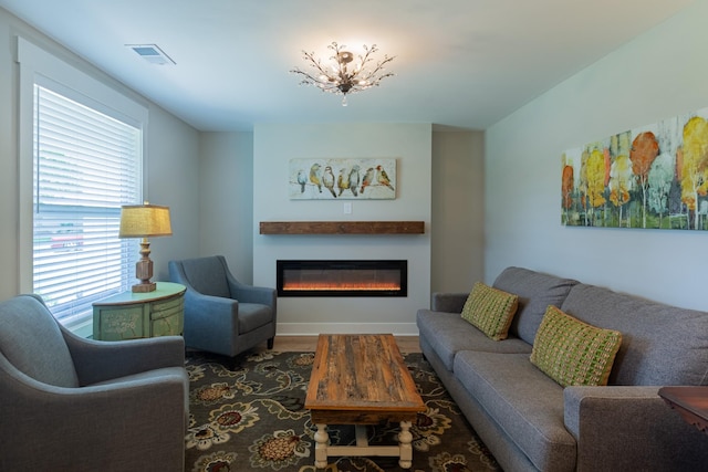 4893 Rainer Dr, Old Hickory, TN 37138 - living room featuring a glass covered fireplace, wood finished floors, and a chandelier