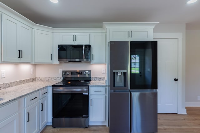 4893 Rainer Dr, Old Hickory, TN 37138 - kitchen with stainless steel appliances, light wood finished floors, white cabinetry, light stone countertops, and recessed lighting