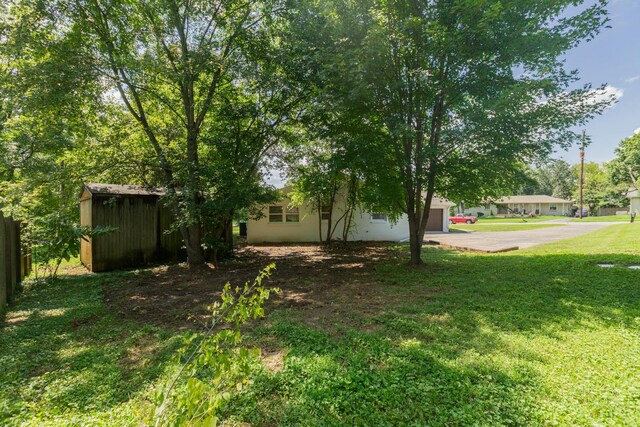 4893 Rainer Dr, Old Hickory, TN 37138 - view of yard featuring a garage, a shed, and driveway