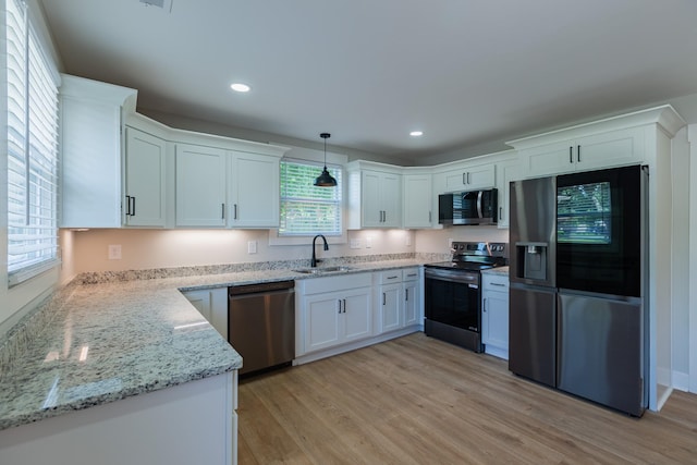4893 Rainer Dr, Old Hickory, TN 37138 - kitchen with stainless steel appliances, light wood-style flooring, white cabinetry, light stone counters, and recessed lighting