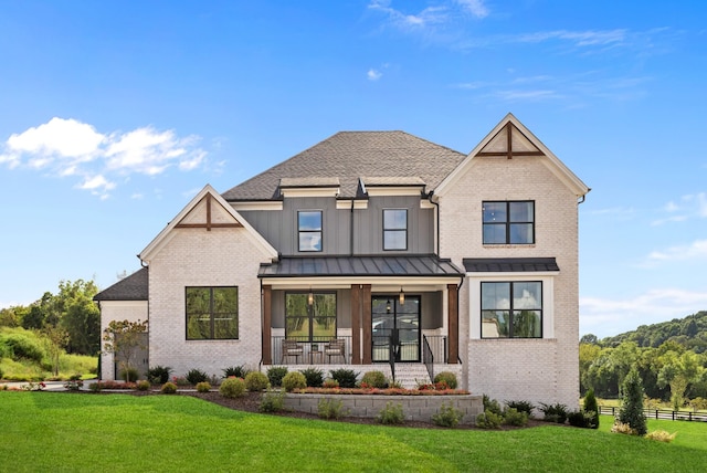 7103A Kyles Creek Dr, Fairview, TN 37062 - view of front of house featuring covered porch, brick siding, a standing seam roof, a shingled roof, and board and batten siding