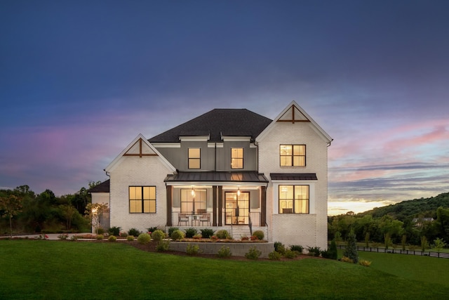 7103A Kyles Creek Dr, Fairview, TN 37062 - back of property at dusk featuring covered porch, a standing seam roof, and a metal roof