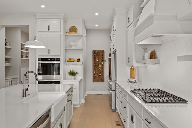 7103A Kyles Creek Dr, Fairview, TN 37062 - kitchen featuring open shelves, appliances with stainless steel finishes, premium range hood, white cabinets, and recessed lighting