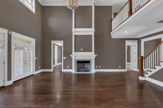 3699 Sweethome Rd, Ashland City, TN 37015 - unfurnished living room featuring a high ceiling, wood finished floors, stairs, a chandelier, and a fireplace with flush hearth