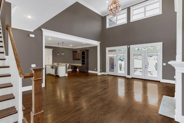 3699 Sweethome Rd, Ashland City, TN 37015 - unfurnished living room with a high ceiling, ornamental molding, a chandelier, stairway, and dark wood-type flooring