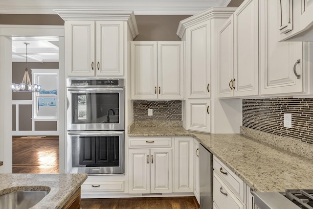 3699 Sweethome Rd, Ashland City, TN 37015 - kitchen featuring stainless steel double oven, dark wood finished floors, a chandelier, ornamental molding, and tasteful backsplash