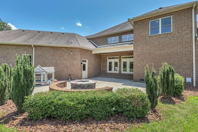 3699 Sweethome Rd, Ashland City, TN 37015 - back of house featuring brick siding, a patio area, a fire pit, and french doors
