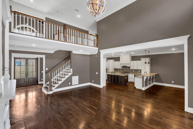 3699 Sweethome Rd, Ashland City, TN 37015 - unfurnished living room featuring stairs, ornamental molding, a chandelier, a high ceiling, and french doors