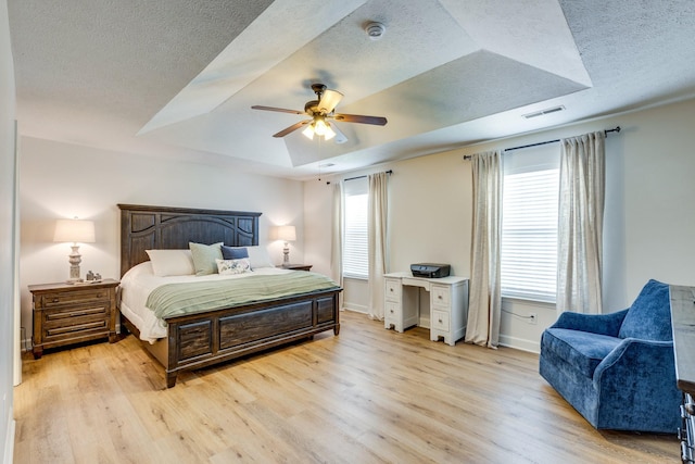 1018 Lowrey Pl, Spring Hill, TN 37174 - bedroom featuring a tray ceiling, light wood-style flooring, a textured ceiling, and a ceiling fan