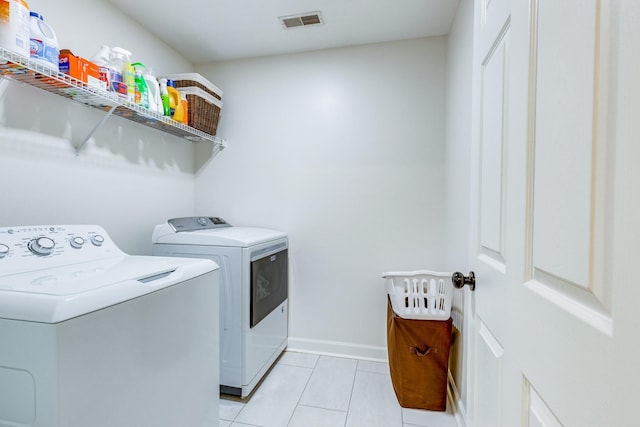 1018 Lowrey Pl, Spring Hill, TN 37174 - washroom featuring washing machine and clothes dryer and light tile patterned floors
