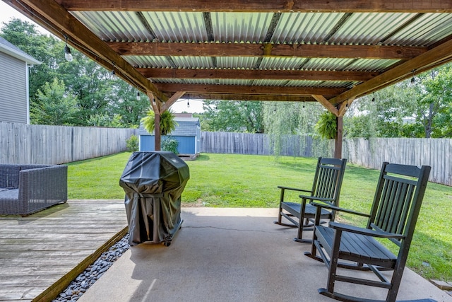 1018 Lowrey Pl, Spring Hill, TN 37174 - fenced backyard featuring a deck, a shed, a grill, and a patio area