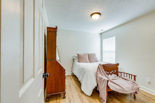 1018 Lowrey Pl, Spring Hill, TN 37174 - bedroom with light wood-style floors and a textured ceiling