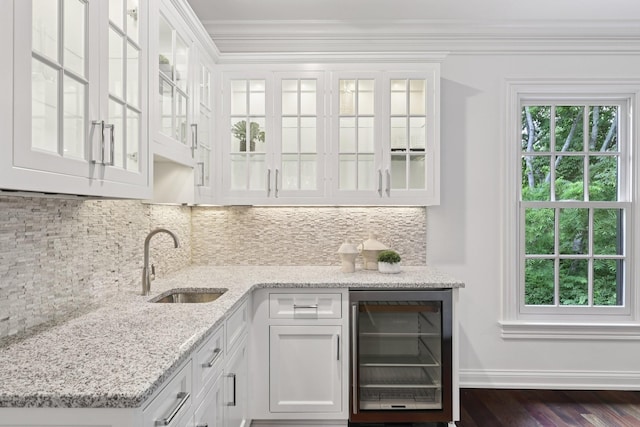3600 Colewood Dr, Nashville, TN 37215 - indoor wet bar with beverage cooler, ornamental molding, decorative backsplash, and dark wood-style floors
