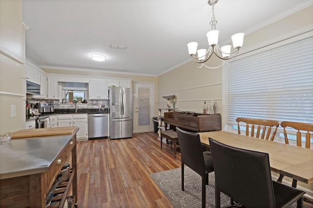 1438 Anita Ct, Murfreesboro, TN 37130 - dining space with crown molding, a chandelier, and wood finished floors